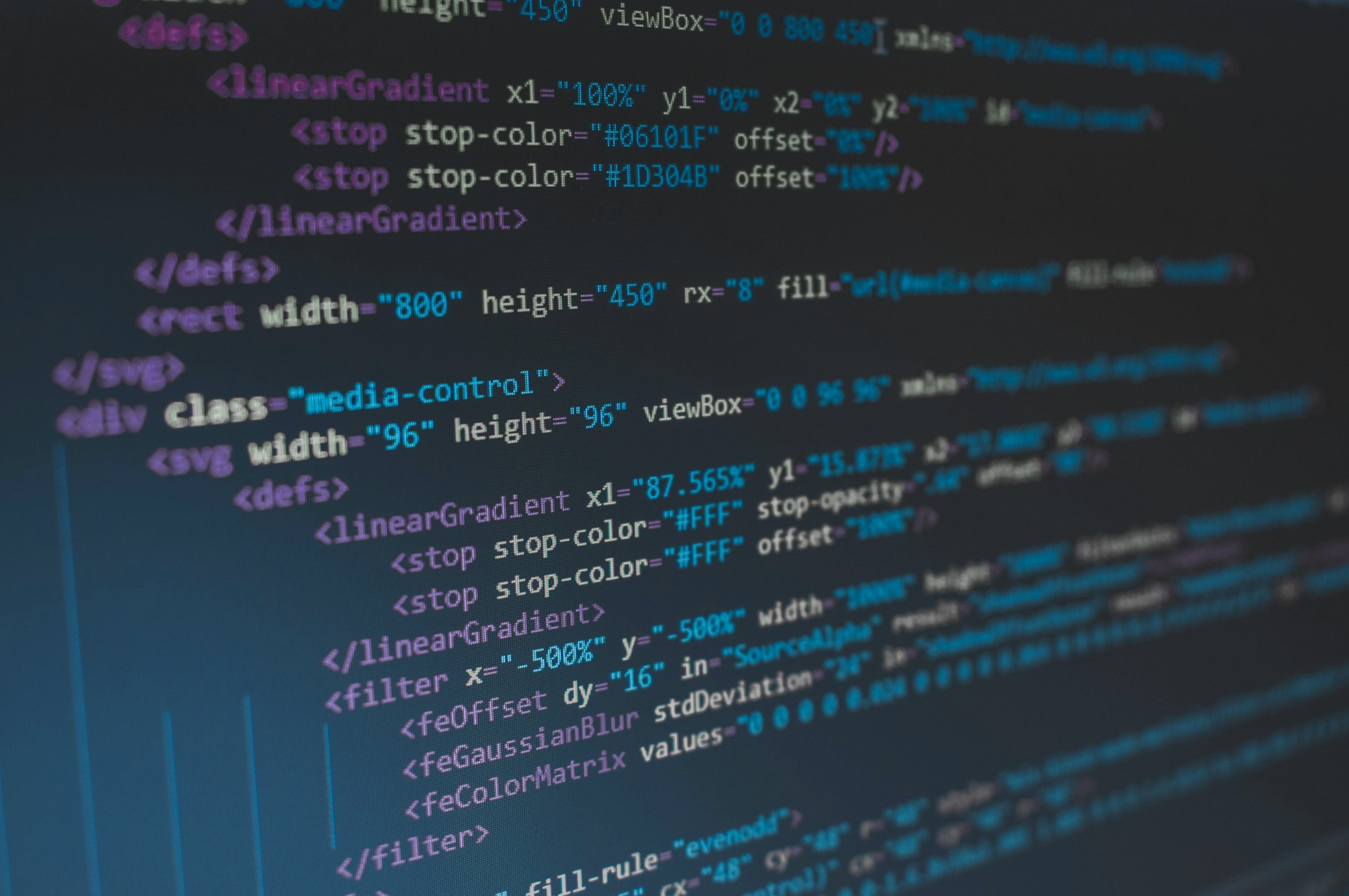 A photo of a computer screen showing HTML code with a variety of color formatting.